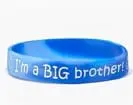 A blue bracelet with the words " i 'm a big brother ".