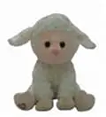 A stuffed lamb sitting on top of a white table.